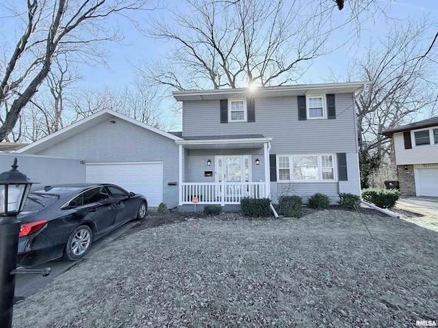 view of front facade featuring a garage, a front lawn, and a porch