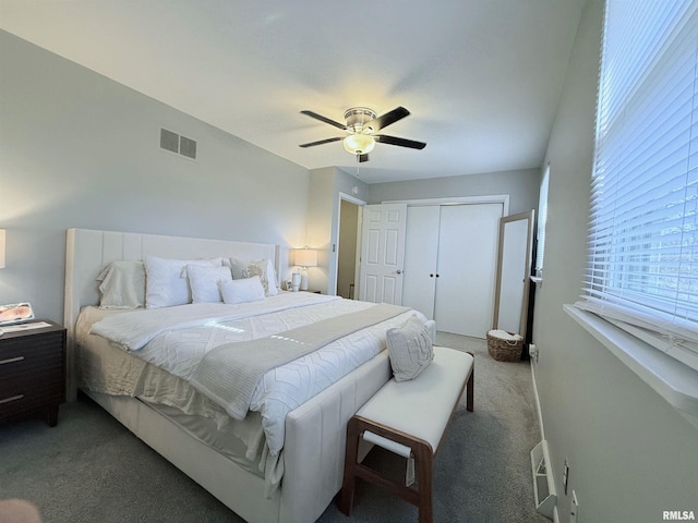 bedroom with a closet, ceiling fan, and dark colored carpet