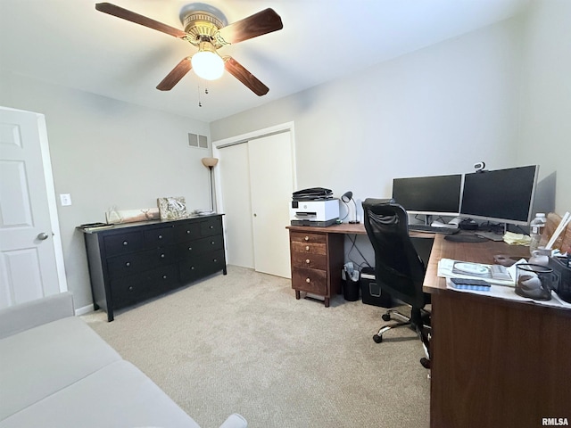 office space featuring light carpet and ceiling fan