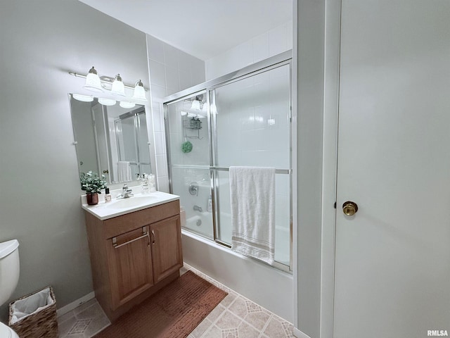 full bathroom with toilet, vanity, and shower / bath combination with glass door