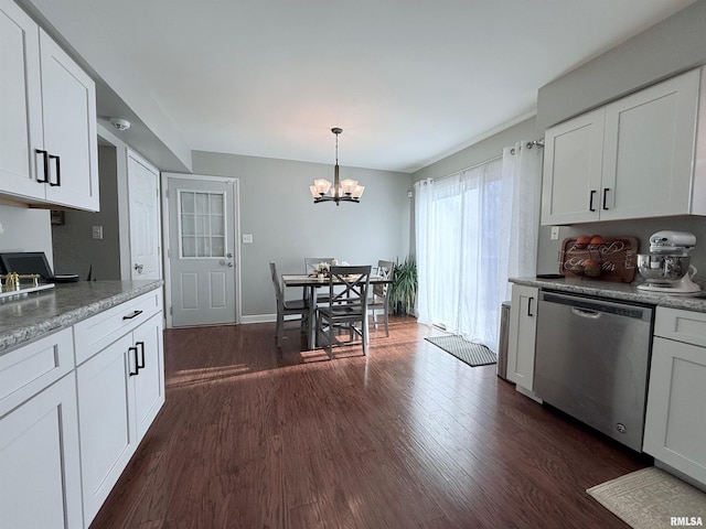 kitchen with hanging light fixtures, dark wood-type flooring, stainless steel dishwasher, white cabinetry, and an inviting chandelier