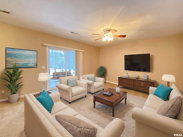 living room featuring ceiling fan and light colored carpet