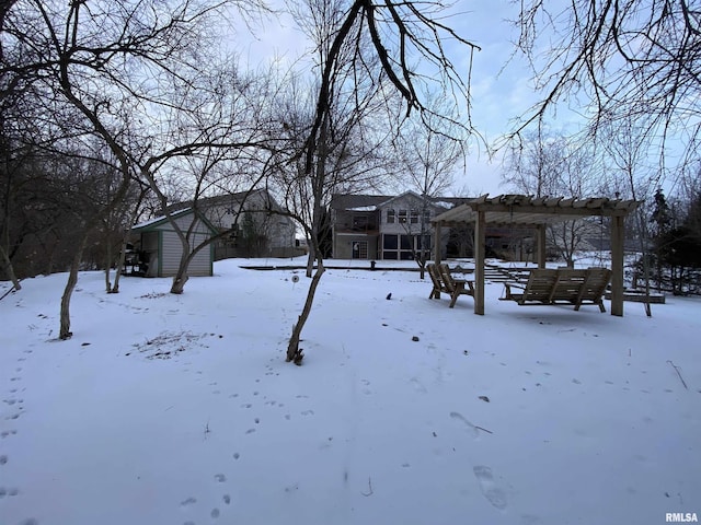 snowy yard with a pergola