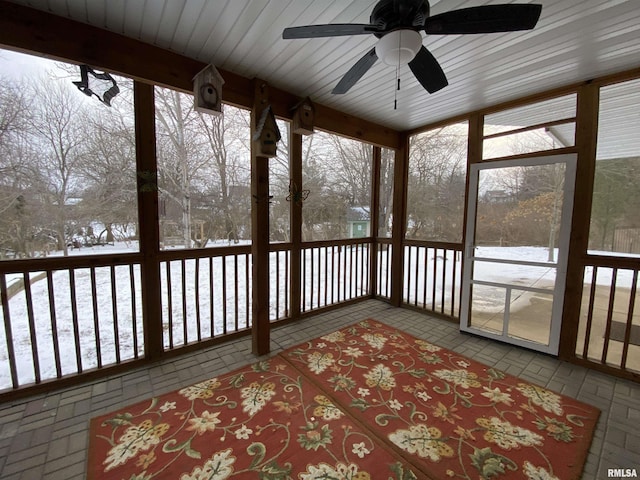 unfurnished sunroom with ceiling fan and a wealth of natural light