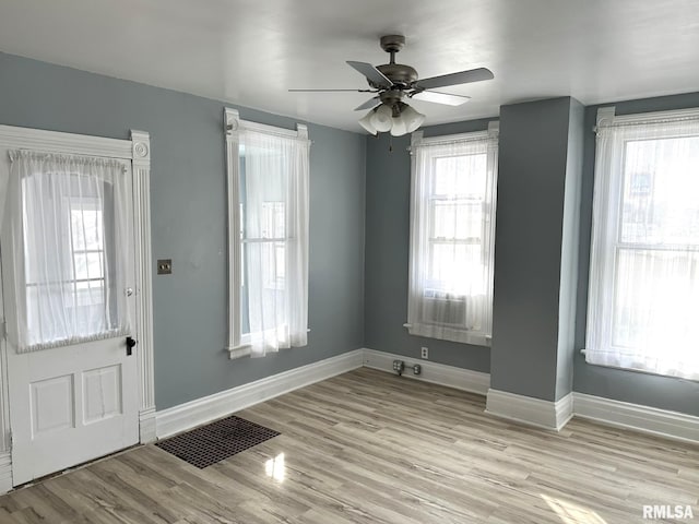 entryway with light wood-type flooring and ceiling fan