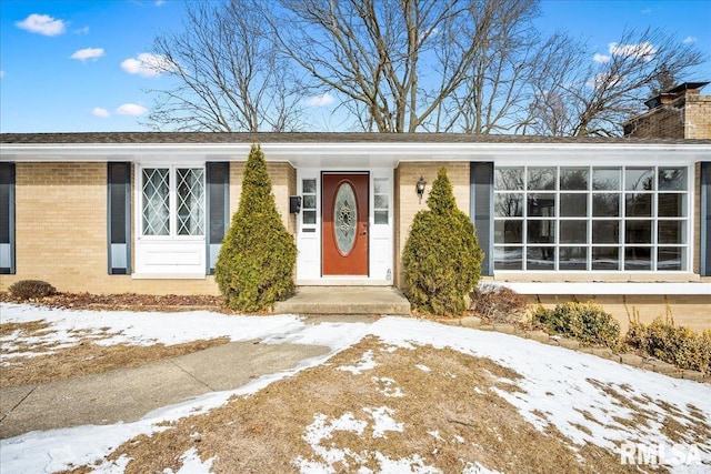 view of snow covered property entrance