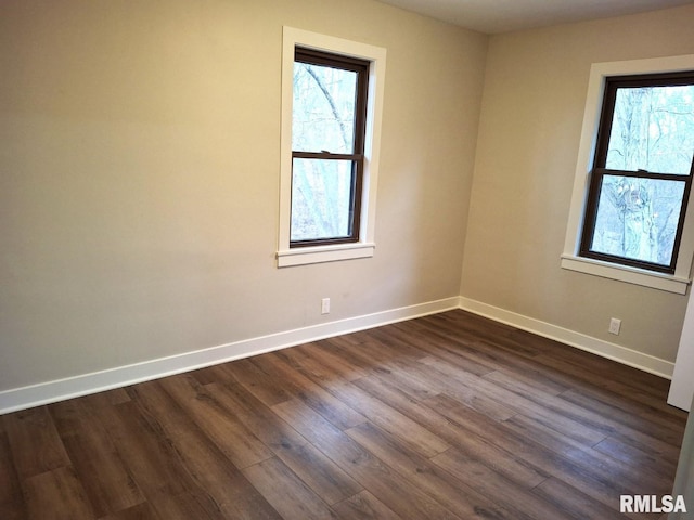 300 E 4th St, Saint David, IL 61563 - unfurnished room featuring a wealth of natural light, dark wood-style flooring, and baseboards