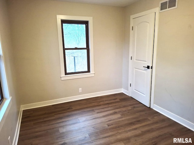 300 E 4th St, Saint David, IL 61563 - unfurnished room featuring baseboards and dark wood-type flooring