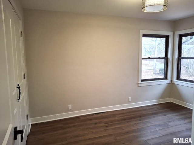 300 E 4th St, Saint David, IL 61563 - empty room with visible vents, dark wood finished floors, and baseboards