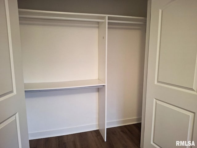 300 E 4th St, Saint David, IL 61563 - unfurnished bedroom with dark wood finished floors, visible vents, a closet, and baseboards