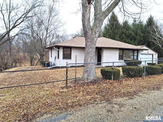 300 E 4th St, Saint David, IL 61563 - bungalow with roof with shingles, cooling unit, brick siding, and a fenced front yard