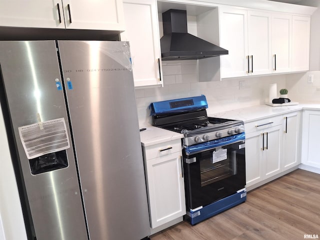 300 E 4th St, Saint David, IL 61563 - kitchen featuring wall chimney exhaust hood, stainless steel refrigerator with ice dispenser, light wood-style flooring, gas range oven, and white cabinets