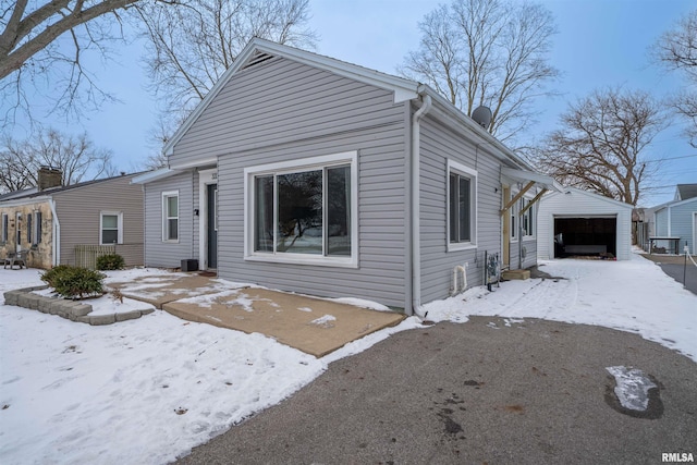 view of front of house with a garage and an outdoor structure