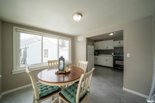 dining room featuring visible vents and baseboards