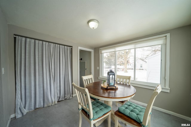 dining area featuring baseboards