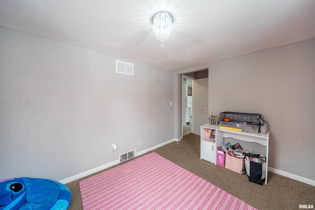 bedroom with dark carpet, visible vents, and baseboards