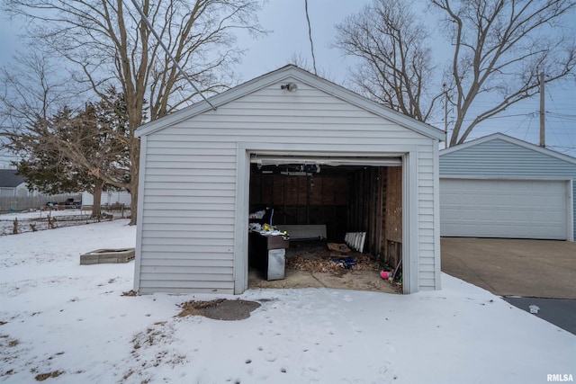 snow covered garage featuring a garage