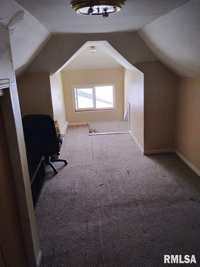 additional living space with carpet flooring, vaulted ceiling, and baseboards