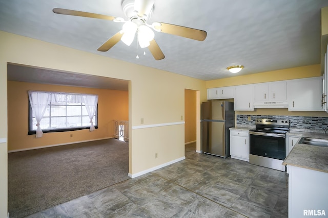 kitchen featuring under cabinet range hood, stainless steel appliances, carpet flooring, white cabinets, and light countertops