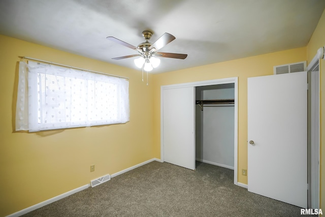 unfurnished bedroom featuring dark carpet, visible vents, and baseboards