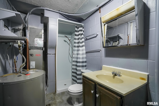 full bathroom featuring water heater, a stall shower, vanity, and concrete block wall