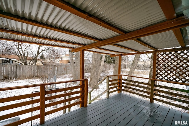 snow covered deck featuring fence