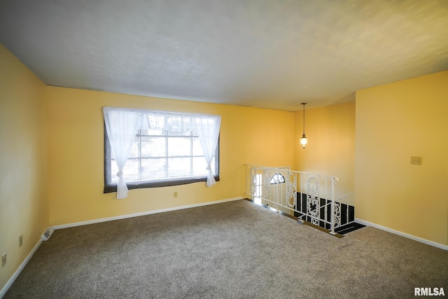 unfurnished living room with carpet flooring and baseboards