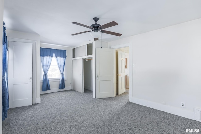 unfurnished bedroom with carpet, baseboards, ceiling fan, and a closet