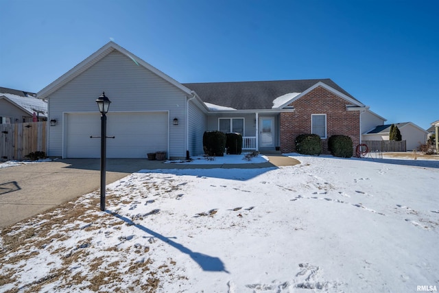 ranch-style home featuring an attached garage, driveway, fence, and brick siding