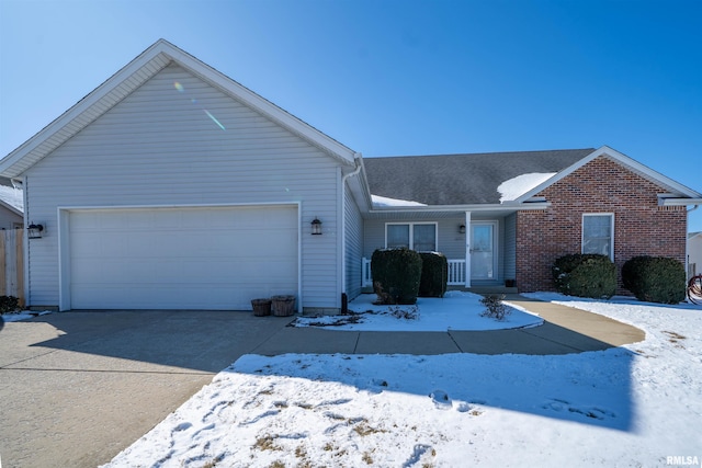 single story home with driveway, brick siding, and an attached garage