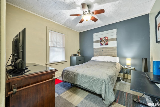 bedroom featuring ornamental molding, an ornate ceiling, and a ceiling fan