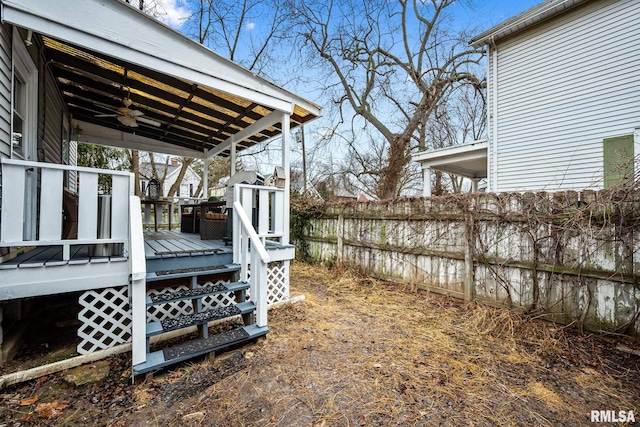 view of yard featuring a fenced backyard, a ceiling fan, and a wooden deck