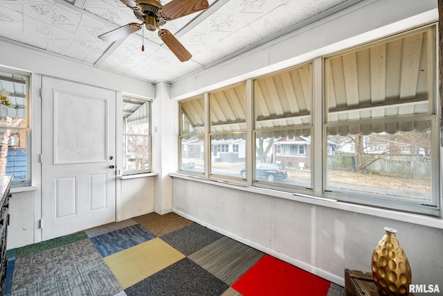 sunroom featuring ceiling fan