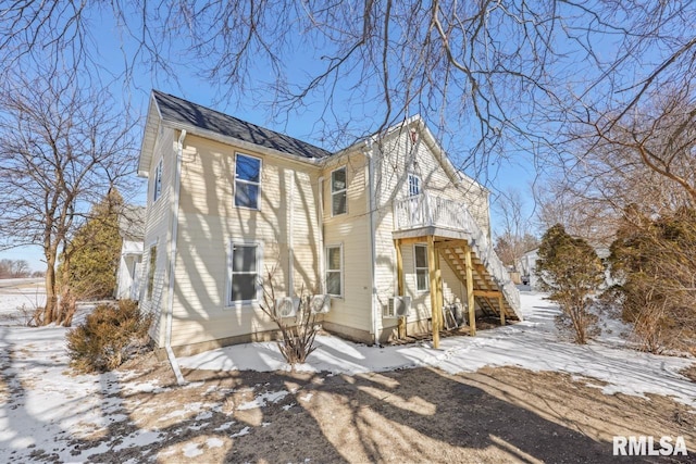 view of front of house with a shingled roof and stairway