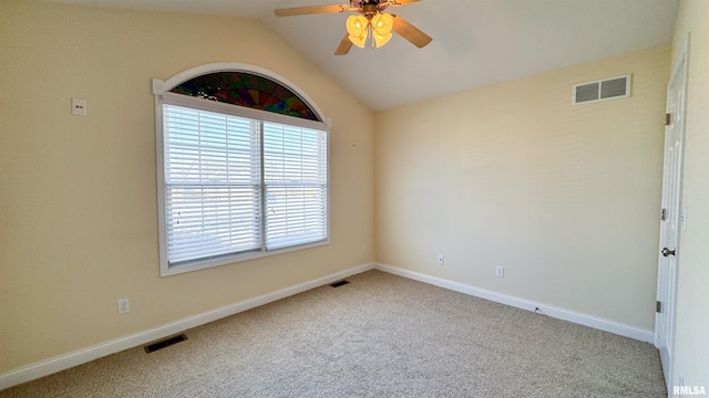 empty room featuring lofted ceiling, visible vents, light carpet, and baseboards