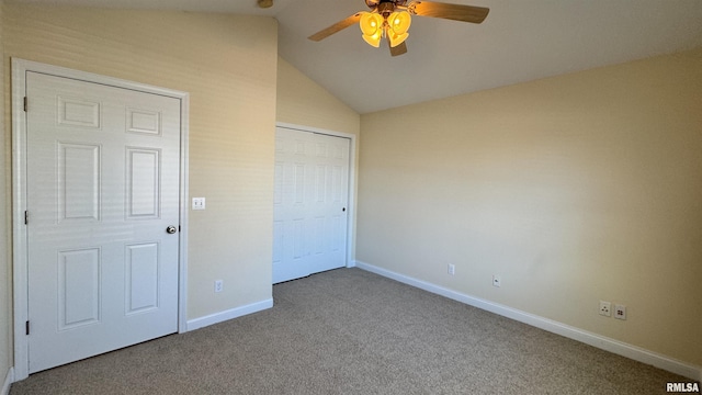 unfurnished bedroom with carpet floors, a closet, vaulted ceiling, ceiling fan, and baseboards