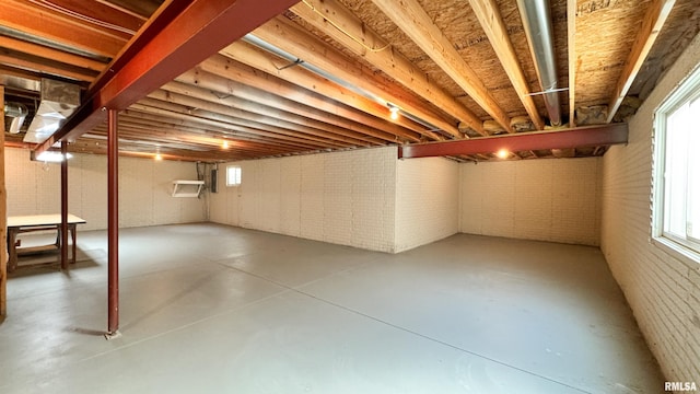 basement featuring brick wall