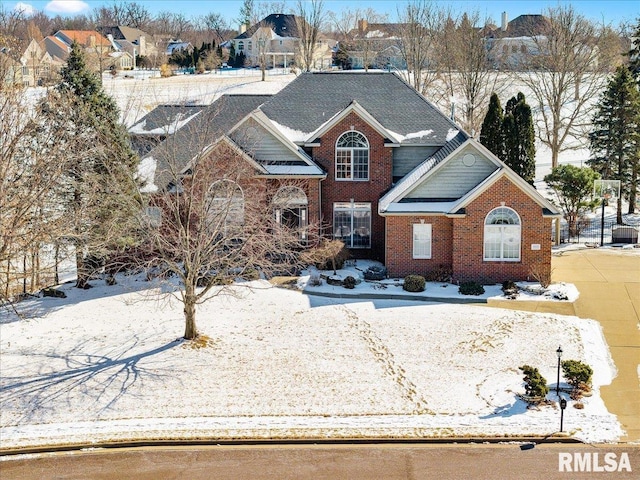 traditional-style home with a residential view and brick siding