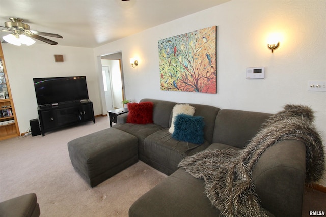 living room featuring a ceiling fan and light carpet