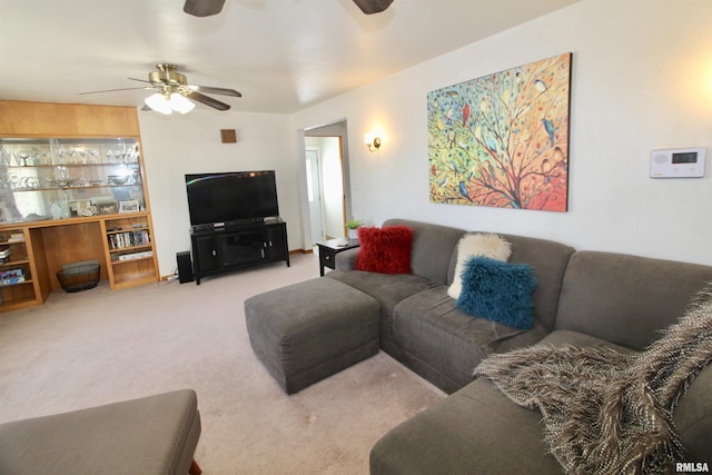 living room featuring a ceiling fan and light colored carpet