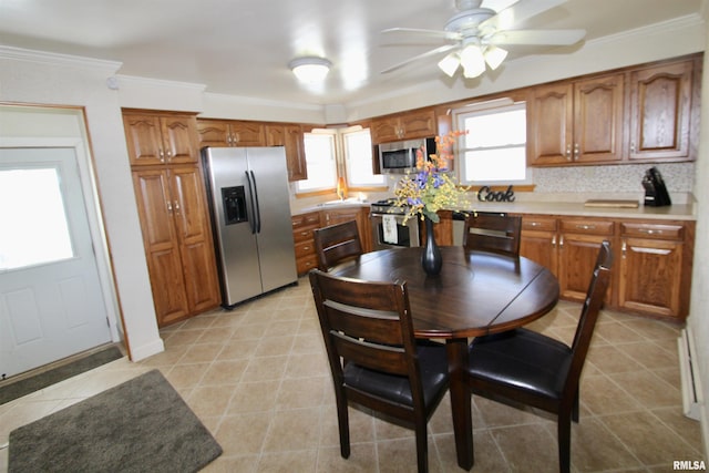 kitchen featuring brown cabinets, stainless steel appliances, light countertops, decorative backsplash, and ornamental molding