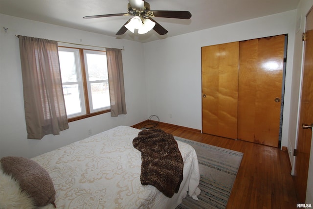 bedroom featuring ceiling fan, a closet, and wood finished floors