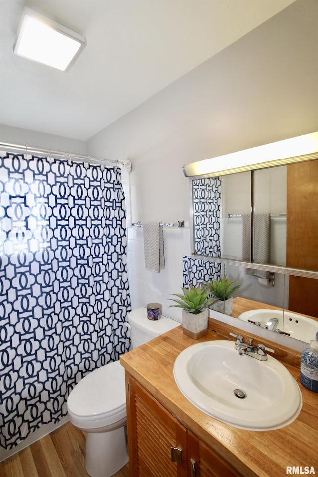 full bath with wood finished floors, vanity, and toilet