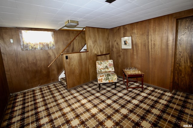 unfurnished room with wooden walls and tile patterned floors