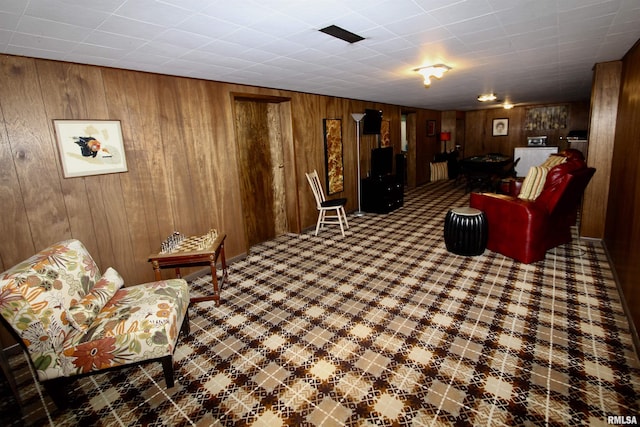 living area featuring wooden walls