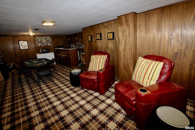 living room featuring bar area and wood walls