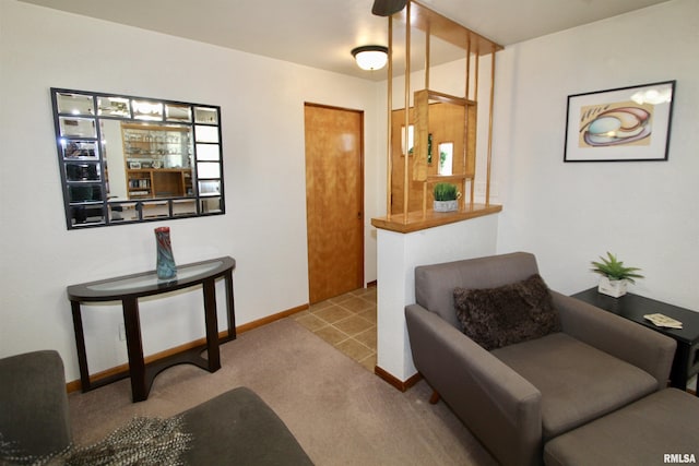 interior space with baseboards and light colored carpet