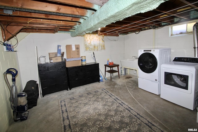 laundry area featuring laundry area, a sink, and independent washer and dryer