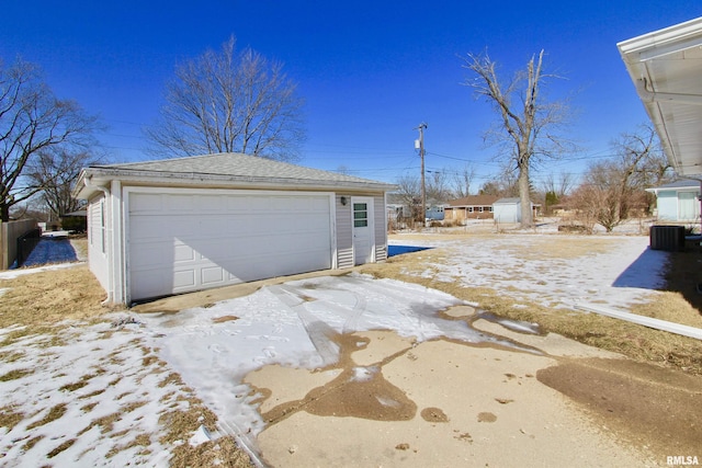 snow covered garage featuring a garage