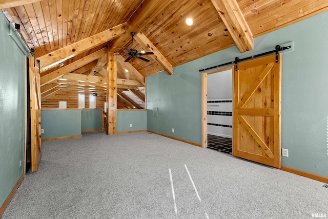 interior space featuring vaulted ceiling with beams, a barn door, carpet floors, wood ceiling, and baseboards